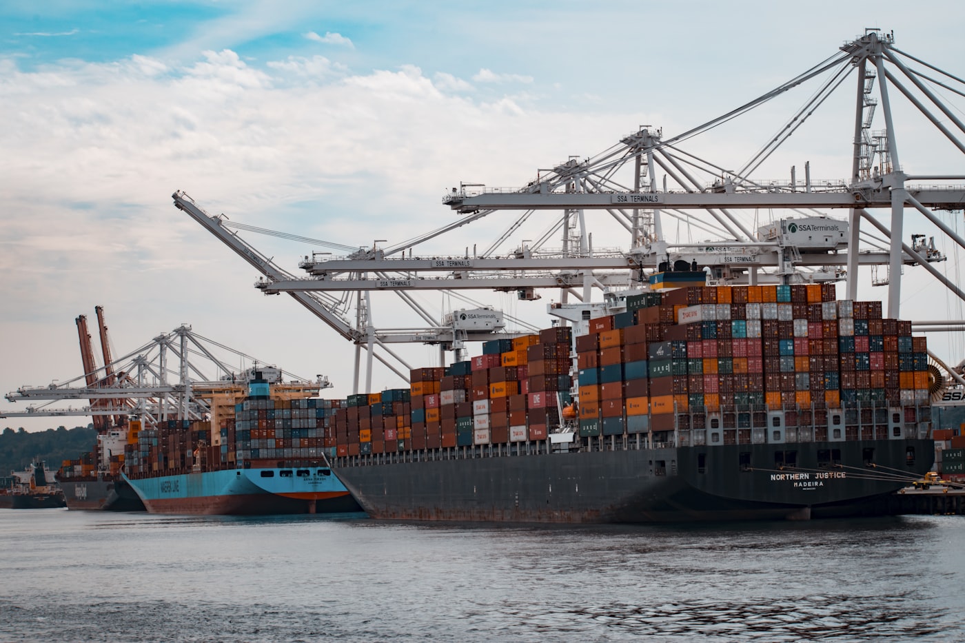 Cargo ships being loaded at port